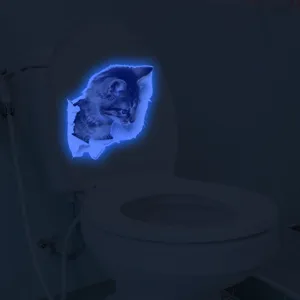 Luminous 3D glowing cat toilet sticker, fluorescent broken wall animal wall decal for bathroom decor.