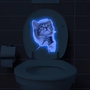 Glow in the dark 3D cat toilet sticker detail shot showing luminous blue effect in dark bathroom.