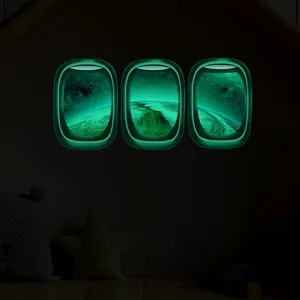 Vue detaillee des autocollants muraux fenetre d'avion lumineux avec design terre espace enfants.