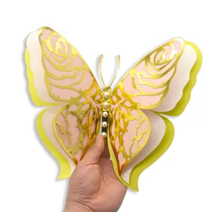 Close-up detail of 3D layered hollow butterfly wall sticker with gold rose pattern and pearls.