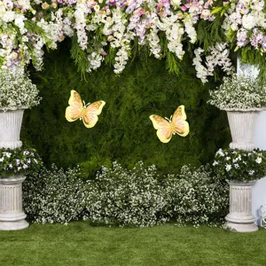 Detailed view of 3D layered butterfly wall stickers in a floral wedding backdrop setting.
