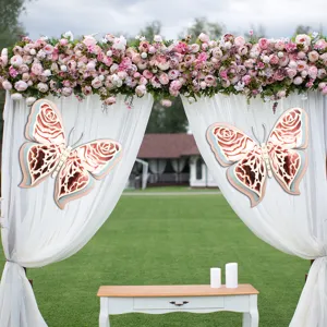 Detail scene of 3D layered pearlescent paper butterfly decorations on wedding arch curtains.