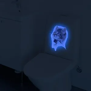 Detailed view of the luminous 3D cat wall sticker glowing blue in the dark for toilet decor.