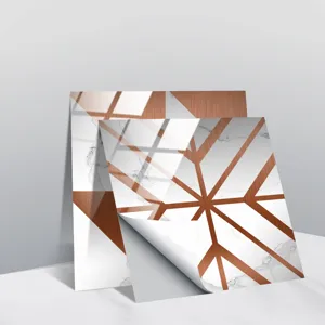 Close-up detail of self-adhesive marble tile sticker with copper geometric lines and peeling corner.