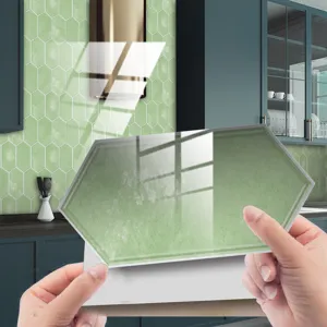 Close-up of vintage green hexagonal peel and stick wall tile sticker for kitchen renovation.