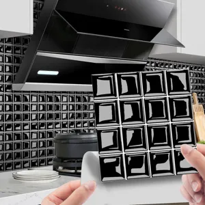 Close up view of self-adhesive 3D black mosaic tile sticker, showing peel and stick detail.
