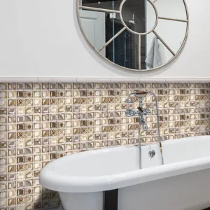 Close-up scene of brown 3D mosaic tile stickers installed on bathroom wall above bathtub.