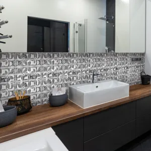 Modern bathroom scene featuring black and white mosaic tile wall stickers, waterproof and easy to use.
