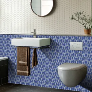Detailed view of blue geometric self-adhesive tile sticker in modern bathroom decor scene.