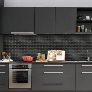 Detail view of self-adhesive black mosaic tile sticker installed in a modern kitchen backdrop.