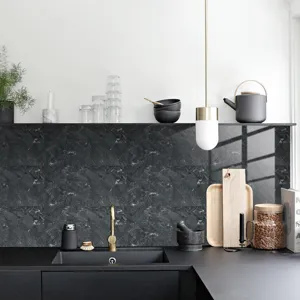Close up view of black marble pattern waterproof tile sticker in modern kitchen setup.