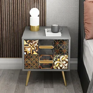Detalle de mesita de noche moderna, cajones con patrón retro, patas doradas, decoración.