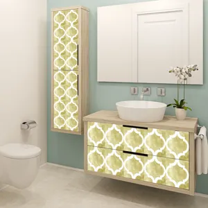 Detail view of yellow quatrefoil tile sticker applied on modern bathroom cabinet surface.