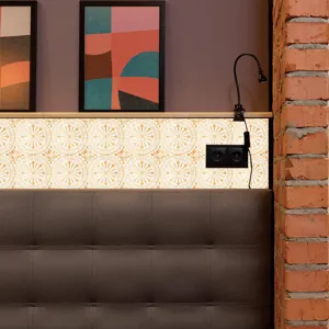 Closeup scene of retro golden mosaic tile sticker applied on bedroom wall above headboard.