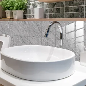 Detailed view of grey marble pattern tile sticker applied on bathroom wall, waterproof.