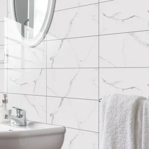 Bathroom detail view of self-adhesive white marble tile stickers with glossy crystal film finish.