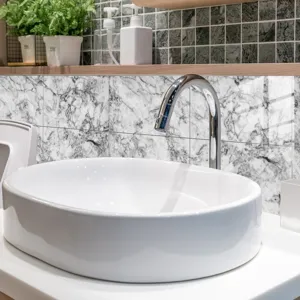 Close-up view of elegant marble pattern tile sticker in modern bathroom, stylish wall decor.