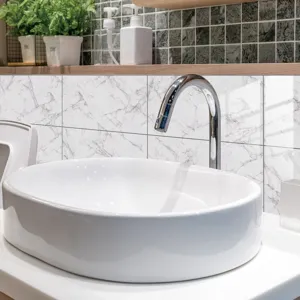 Marble texture tile sticker detail showing realistic stone pattern in modern bathroom sink setting.