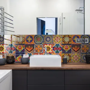 Detailed view of colorful mandala tile stickers decorating a modern bathroom wall scene.
