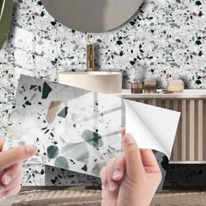 Close-up view of self-adhesive terrazzo tile sticker peel and stick application process.