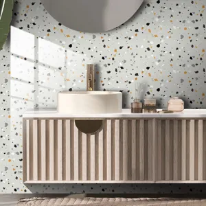 Close-up detail of modern terrazzo pattern wall sticker in a stylish bathroom setting.
