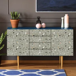 Terrazzo pattern contact paper detail shot showing realistic grey stone texture on furniture surface.