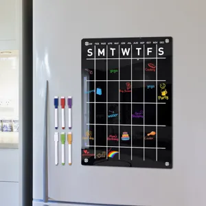 Magnetic acrylic dry erase calendar board for refrigerator with markers for planning.