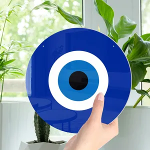 Evil eye mirror wall hanging detail view showing the vibrant blue and white glass design clearly.