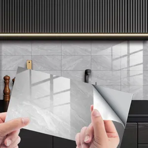 Grey marble texture crystal tile sticker peeling detail showing self-adhesive backing.