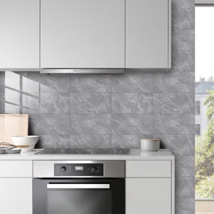 Close-up detail of grey marble texture crystal film tile sticker installed in modern kitchen backsplash.