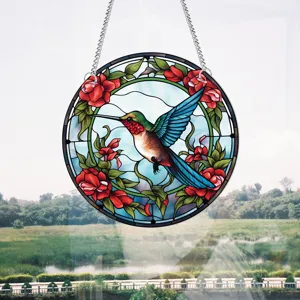 Stained glass hummingbird window hanging with vivid floral design, perfect for home decor.