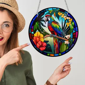 Detail view of a stained glass parrot wall hanging with vibrant colors displayed on a wall.