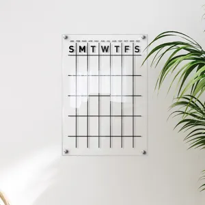 Clear acrylic wall calendar memo board detail showing monthly planner grid and mounts.