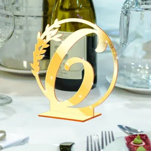 Gold mirror acrylic table number 6 detail, elegant wedding decor centerpiece display.