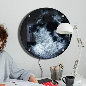 Detailed view of the glowing 3D moon wall lamp mounted in a cozy modern study room.