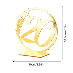 Gold acrylic 20 table number sign with leaf accent, elegant wedding reception display detail.