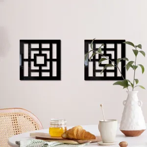 Close-up detail shot of black geometric wall mirror sticker set, elegant home decor scene.