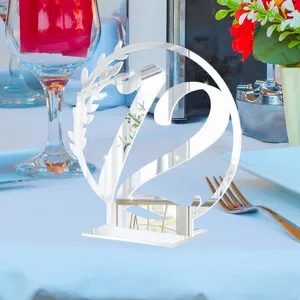 Silver acrylic table number 12 sign detail view, elegant wedding decor centerpiece display scene.