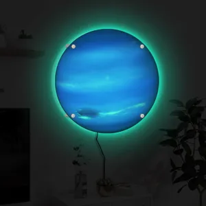 Close-up detail of the glowing planet wall lamp showing vibrant blue texture and green light.