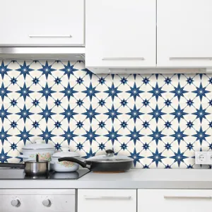 Kitchen backsplash sticker showing dark blue star pattern applied on wall above stove.