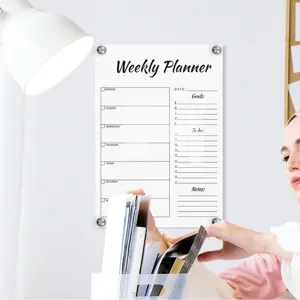 Clear acrylic weekly planner board scene with desk organizer and wall setup detail view.