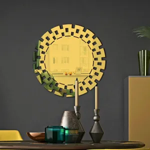 Decorative gold acrylic wall mirror sticker detail, modern geometric cut-out home decor accent.