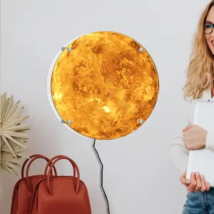 Detailed lifestyle view of the glowing LED planet wall lamp mounted in a modern room setting.