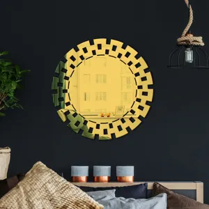 Golden acrylic geometric decorative wall mirror detail showing intricate cutout frame design.