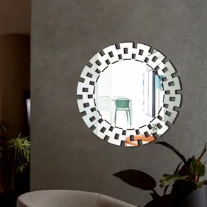 Acrylic round decorative wall mirror with geometric hollow frame for modern home decor detail view.