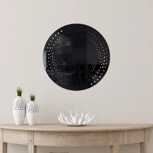 Scene detail of circular decorative wall mirror with dot pattern on wooden console table.