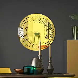 Detail shot of round acrylic wall mirror sticker with black dot pattern in modern room decor.