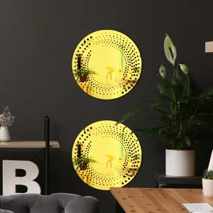 Detailed view of round yellow acrylic wall mirror with black dot swirl pattern in room.