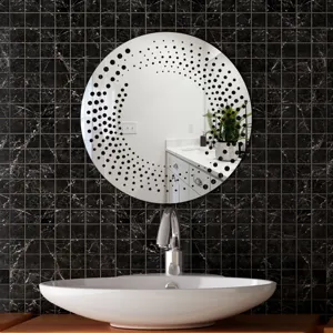 Detailed view of round decorative wall mirror sticker with modern black dot pattern in bathroom.