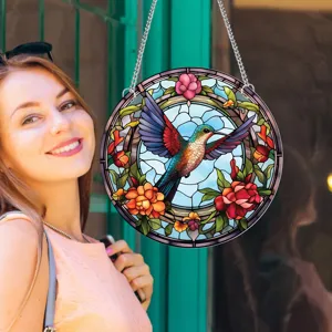 Detailed shot of round stained glass style hanging hummingbird wall decor pendant with chain.